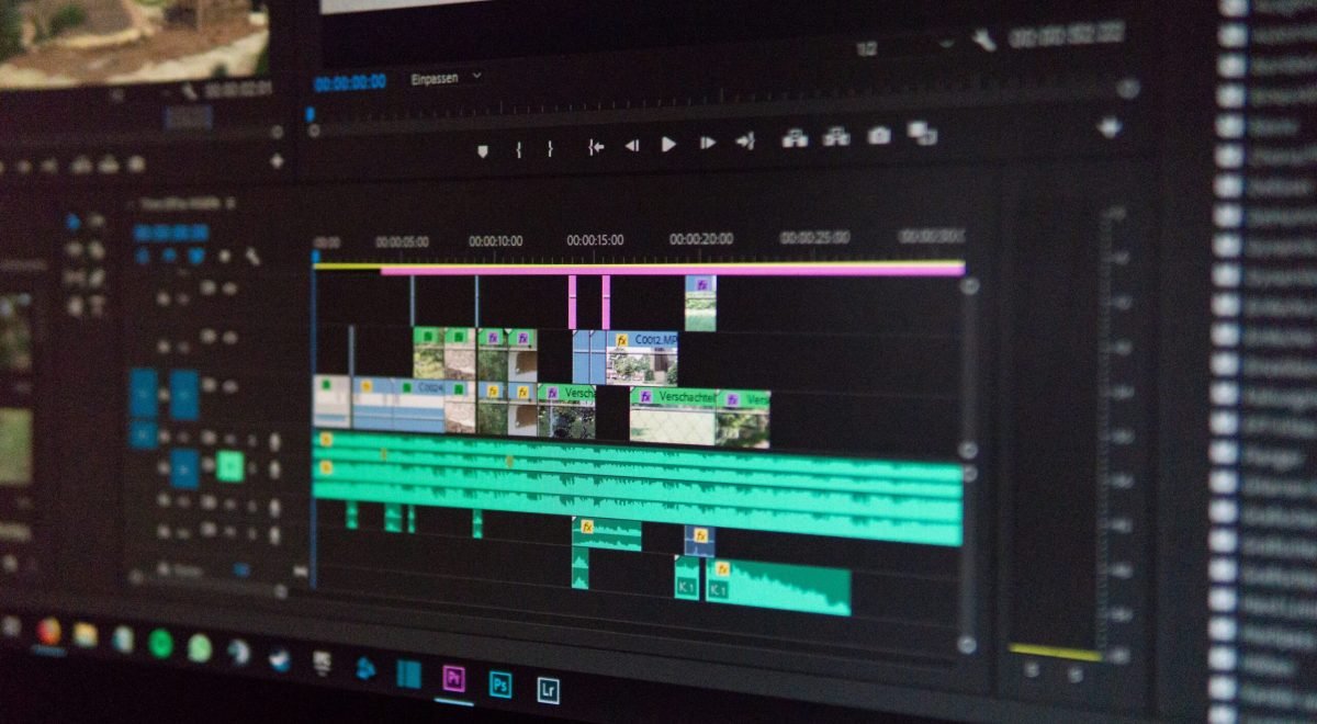 Content creator using AI video generation software to create professional videos on a computer.